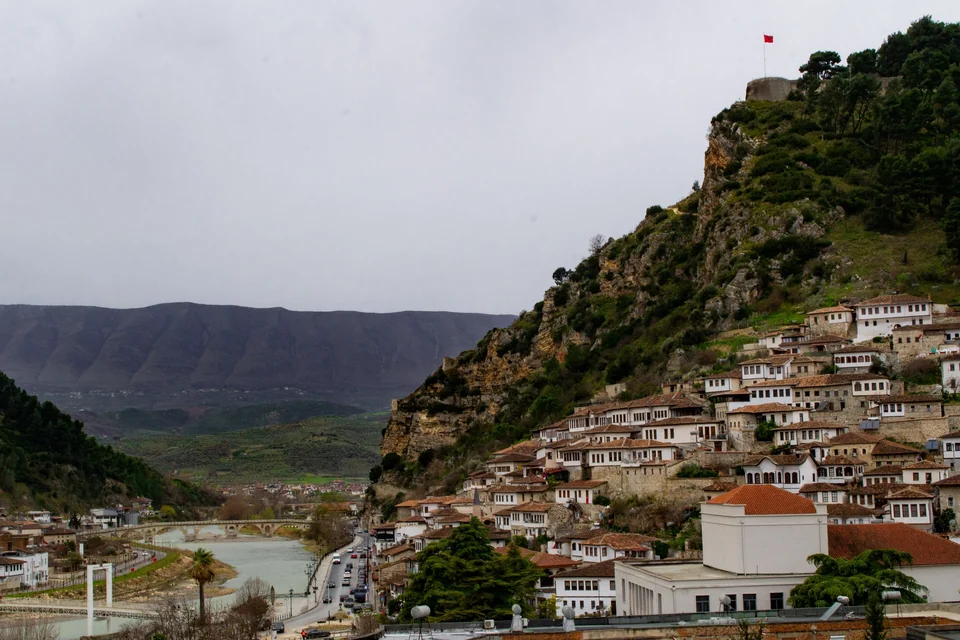 White Ottoman-era houses of Berat's Mangalem quarter climbing the castle hill above the Osum River in Albania
