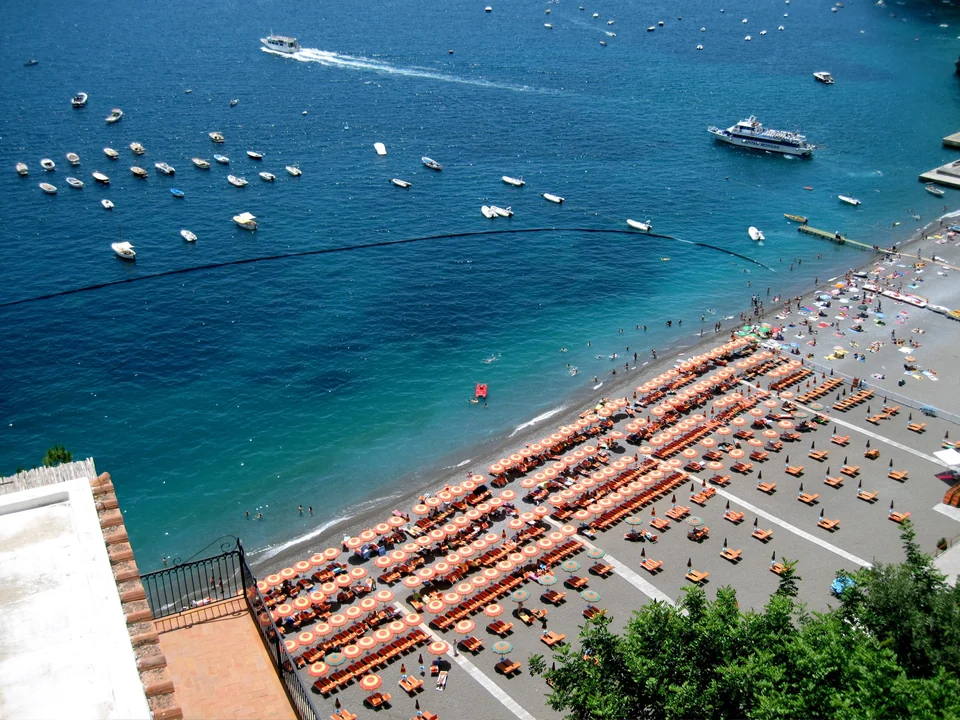 Positano's beach and pastel houses climbing the hillside on the Amalfi Coast, Italy