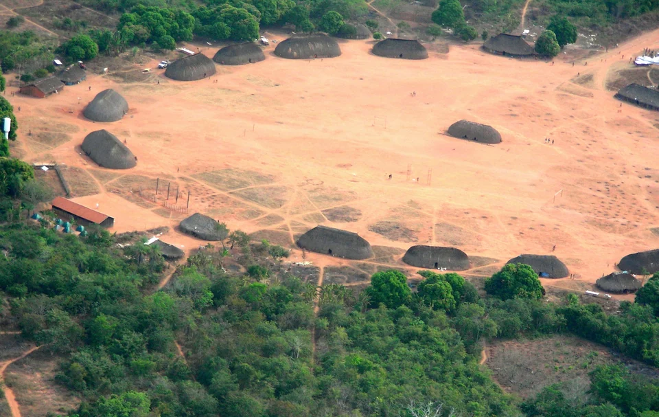 Aerial view of Ipatse, a Kuikuro village with thatched houses around a large circular plaza in the Xingu, Brazil