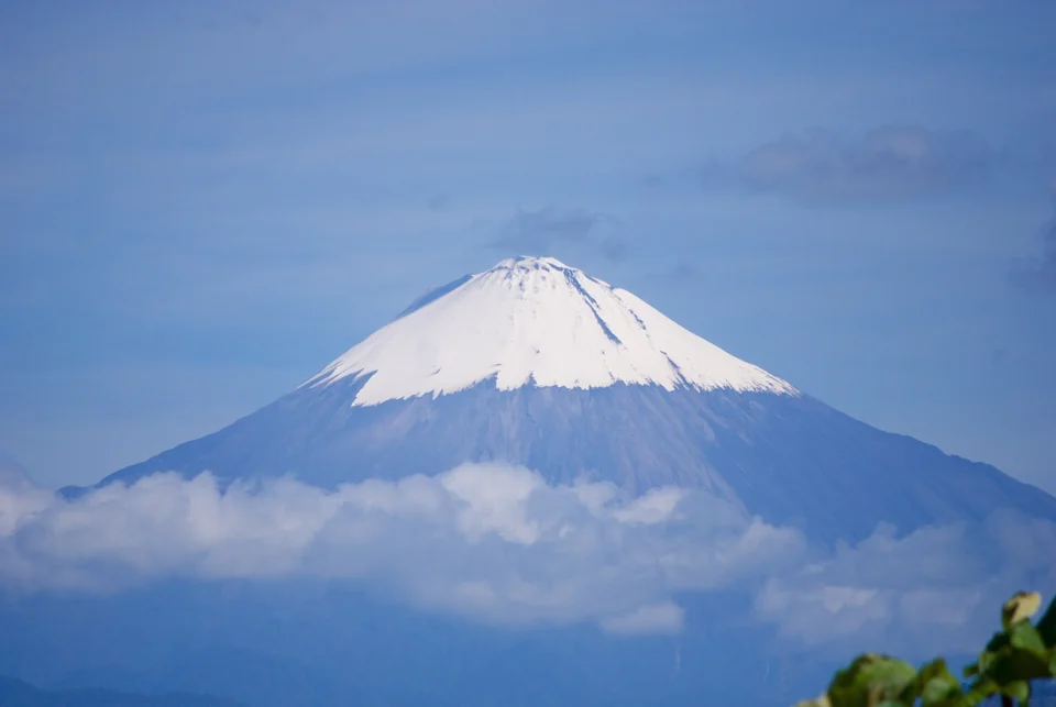 Snow-capped Sangay volcano rising above forested ridges, seen from Macas in Ecuador’s Upano Valley