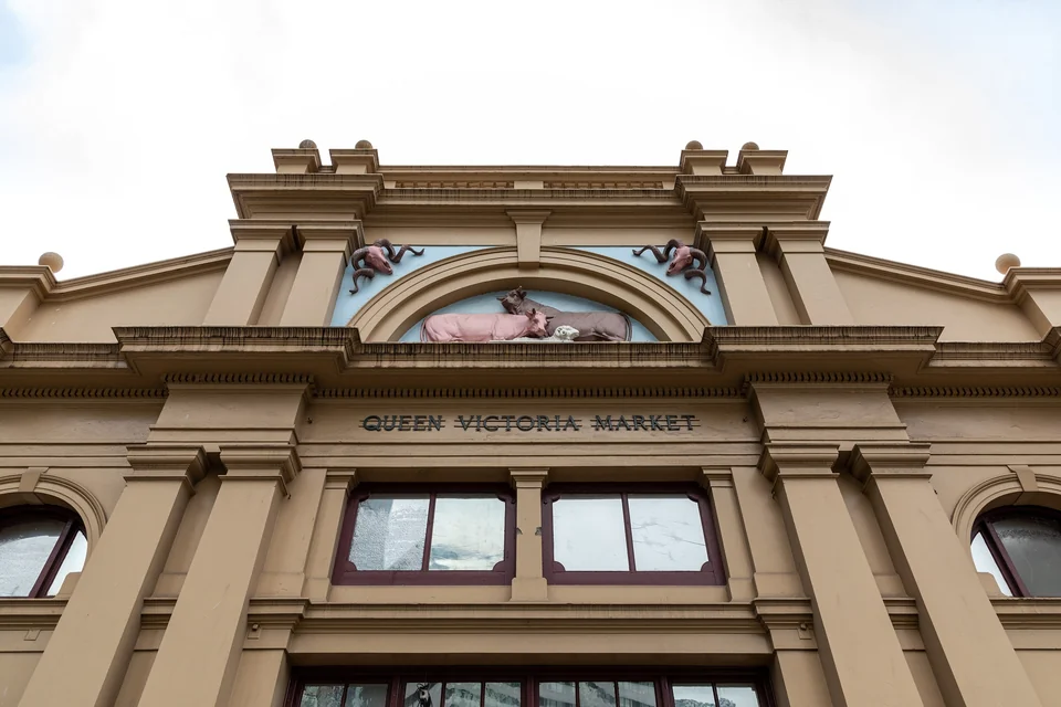 Ornate facade of the Queen Victoria Market in Melbourne with carved animal figures above the entrance