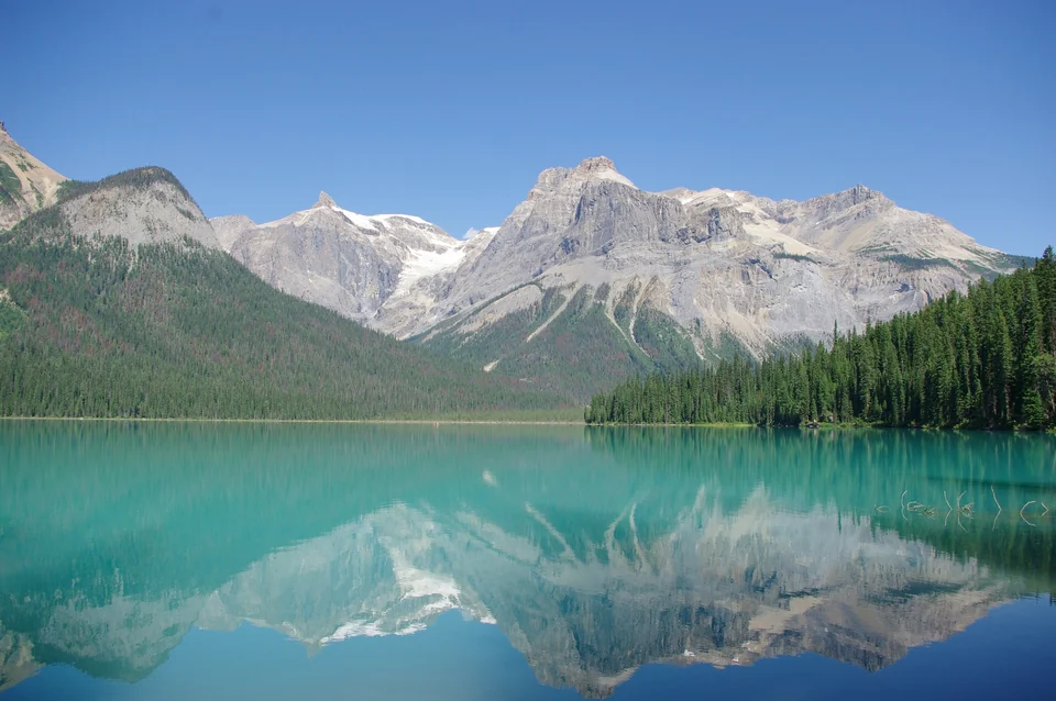 Emerald Lake in Yoho National Park, British Columbia, with forested mountains rising behind the green water