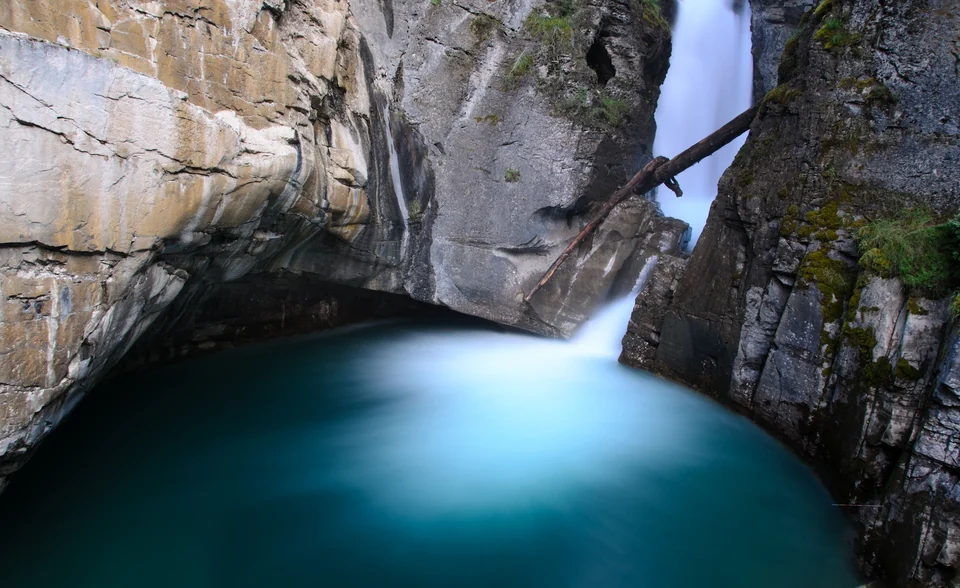Lower Falls plunging into a narrow limestone gorge in Johnston Canyon, Banff National Park