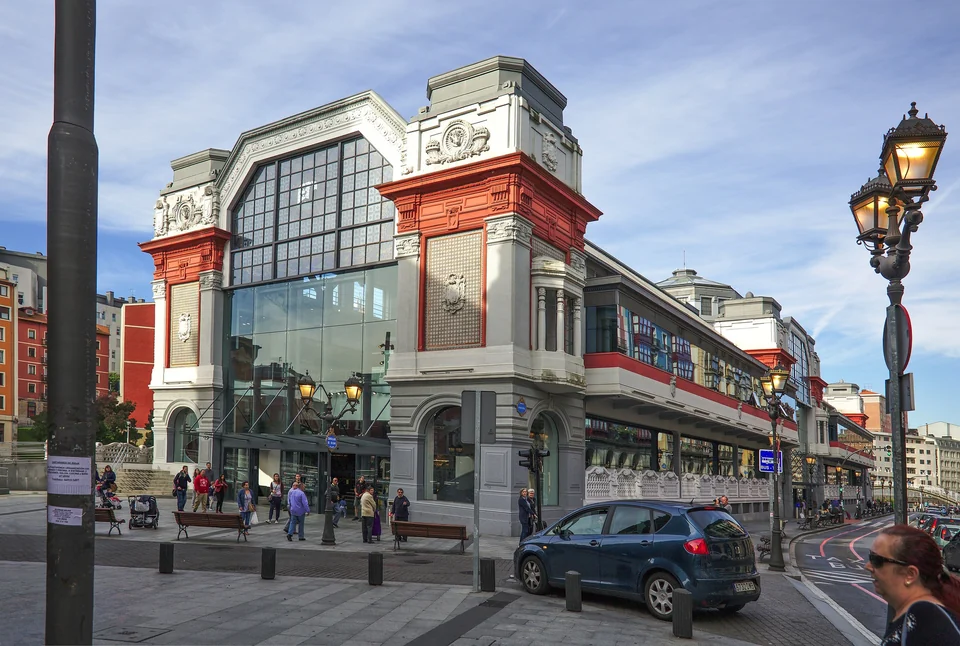 Art Deco facade of the Mercado de la Ribera food market in Bilbao with shoppers outside