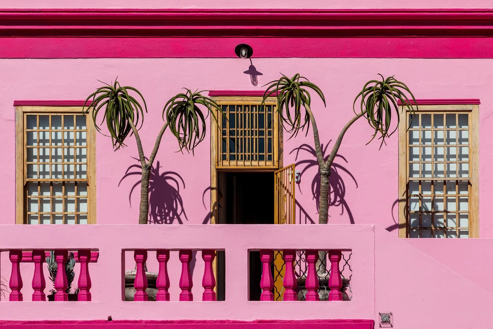 Row of brightly painted houses in pink, green and yellow on Wale Street in Cape Town's Bo-Kaap
