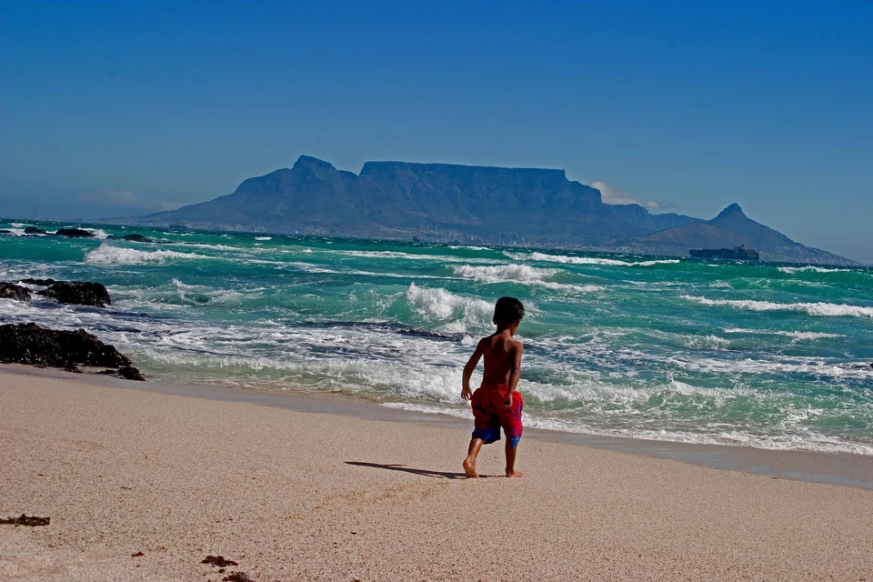 Table Mountain and Lion's Head rising behind Cape Town, seen across Table Bay from the beach at Blouberg