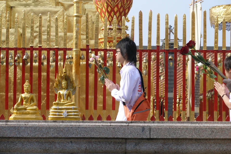 The golden chedi of Wat Phra That Doi Suthep surrounded by gilded parasols on the mountain above Chiang Mai