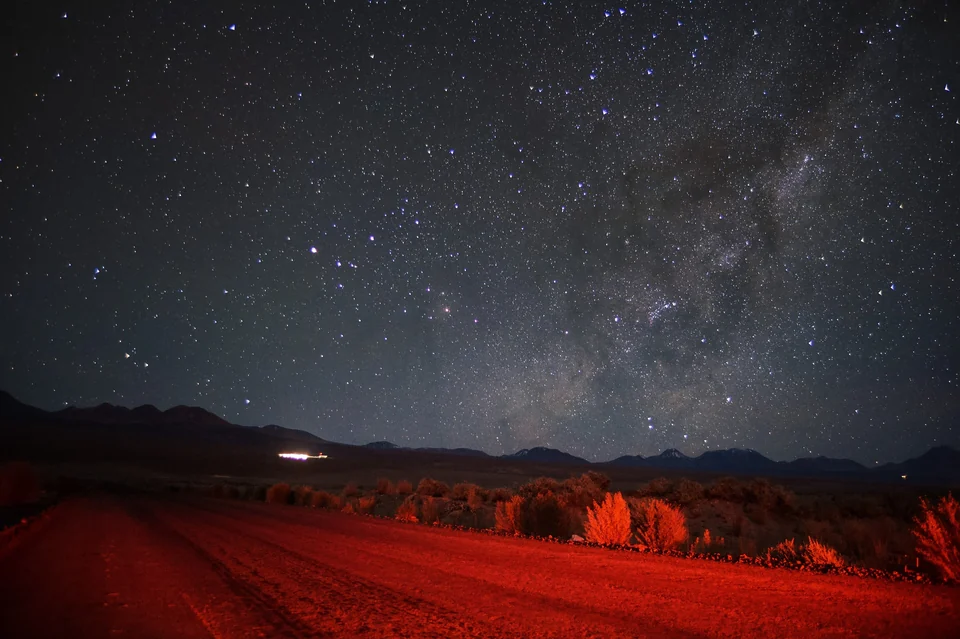 The Milky Way rising over the dark desert horizon of the Atacama in northern Chile