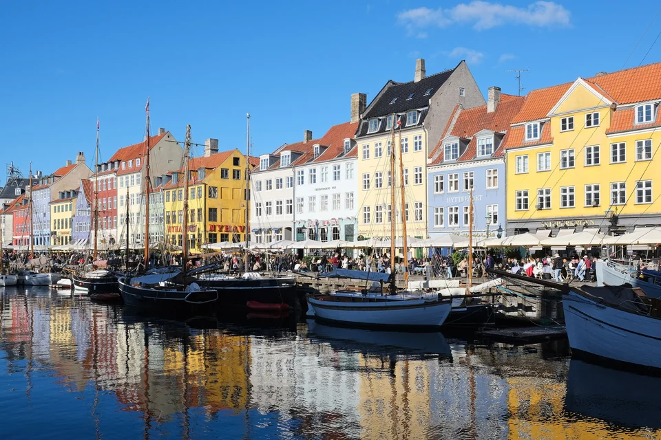 Colorful 17th- and 18th-century townhouses and wooden sailing boats along the Nyhavn canal in Copenhagen