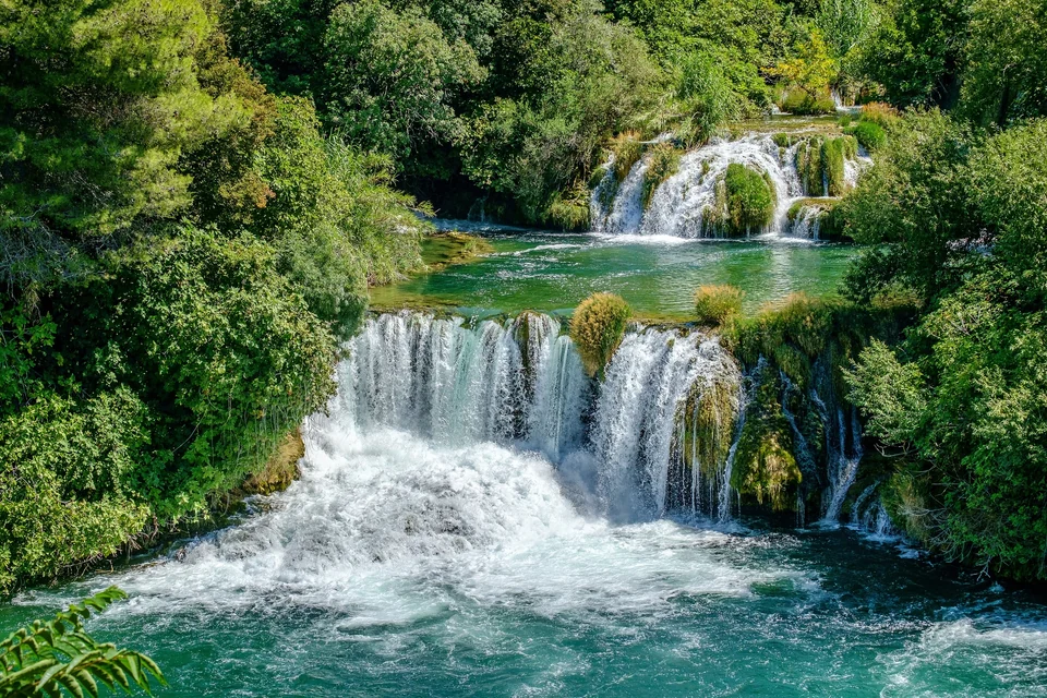 Skradinski buk waterfall in Krka National Park spilling over green travertine terraces into a pool