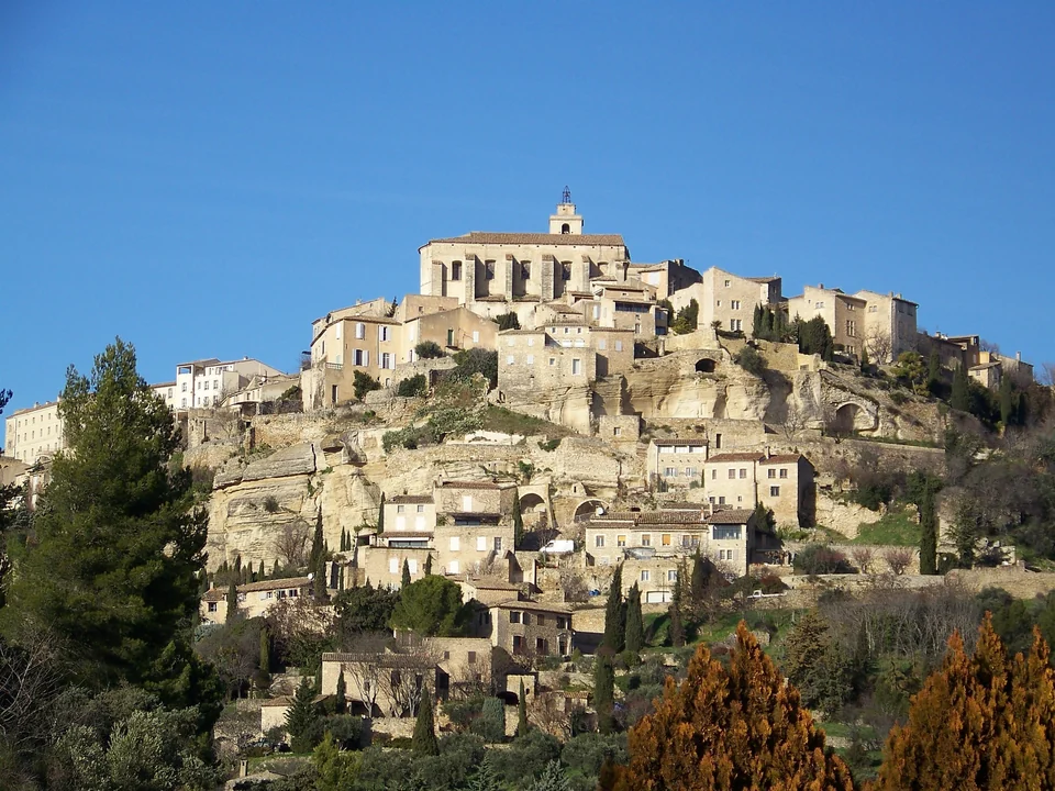The hilltop village of Gordes in the Luberon with stone houses stacked below its castle and church