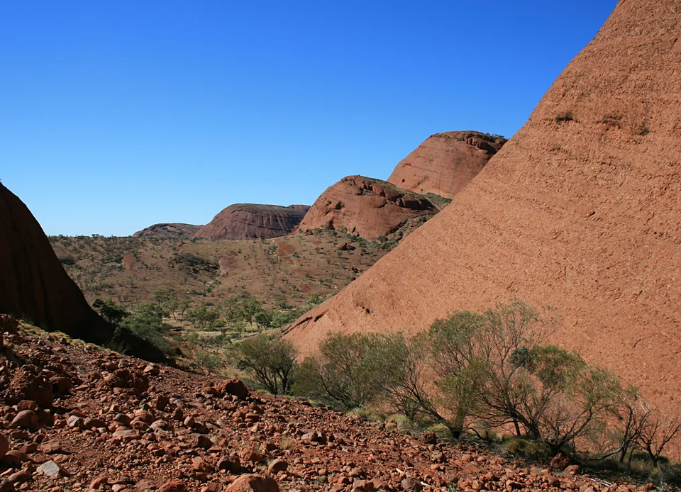 Red rounded rock domes of Kata Tjuta above desert shrubs in Uluru-Kata Tjuta National Park, Northern Territory
