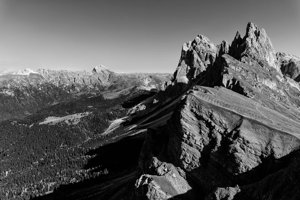 Grassy ridge at Seceda in Val Gardena with the jagged Odle peaks rising beyond under a clear sky