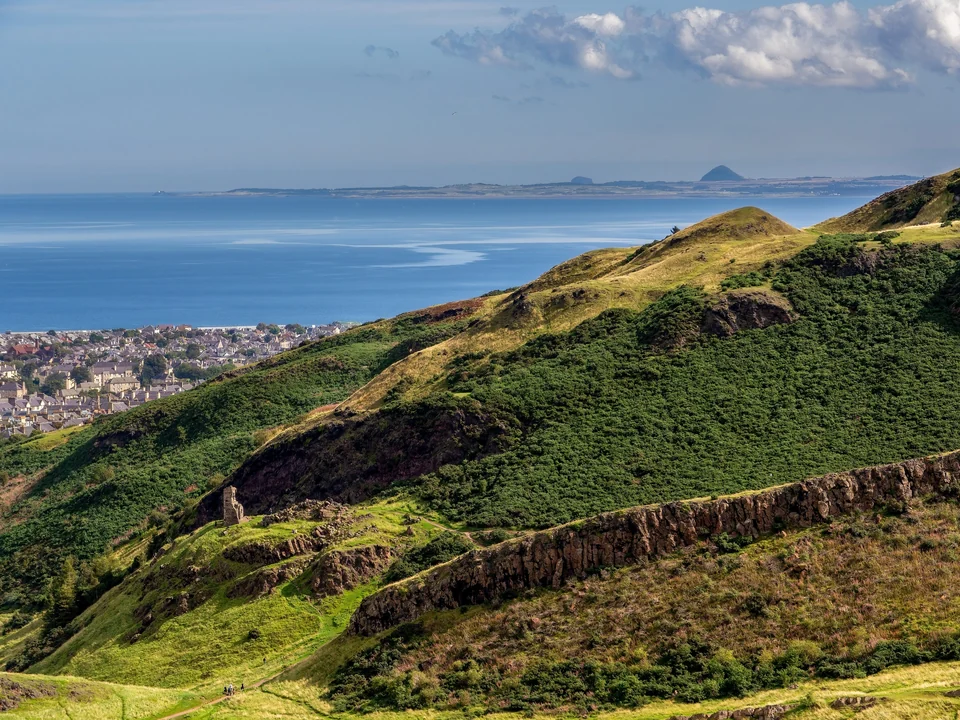 View across Holyrood Park from Arthur's Seat toward the city of Edinburgh and the Firth of Forth