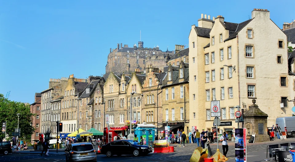 Edinburgh Castle on its rock above the rooftops and streets of the Grassmarket in Edinburgh, Scotland