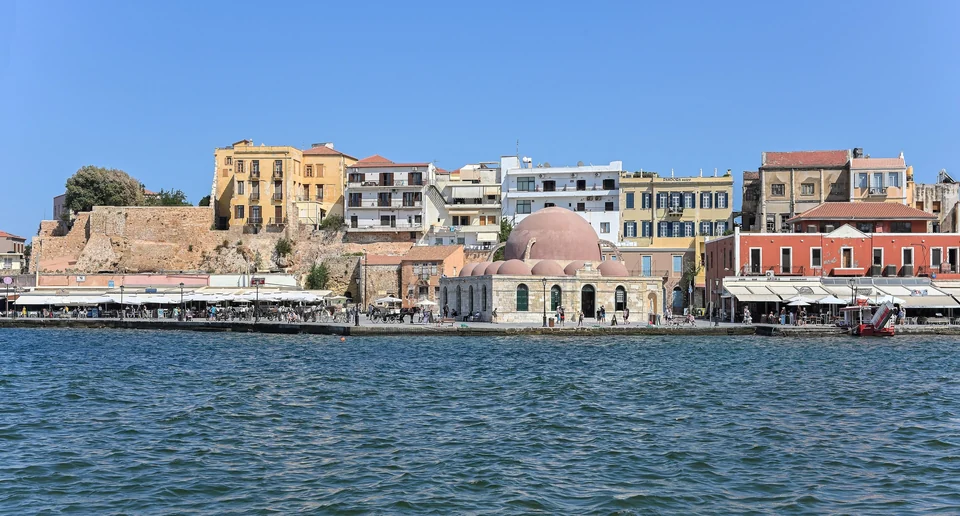 Venetian old harbor of Chania on Crete with colorful waterfront buildings and the lighthouse