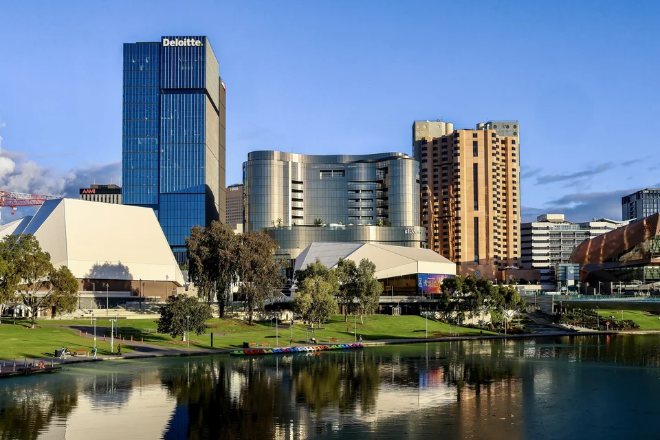 Adelaide city skyline and the white Adelaide Festival Centre reflected in the River Torrens on a clear day