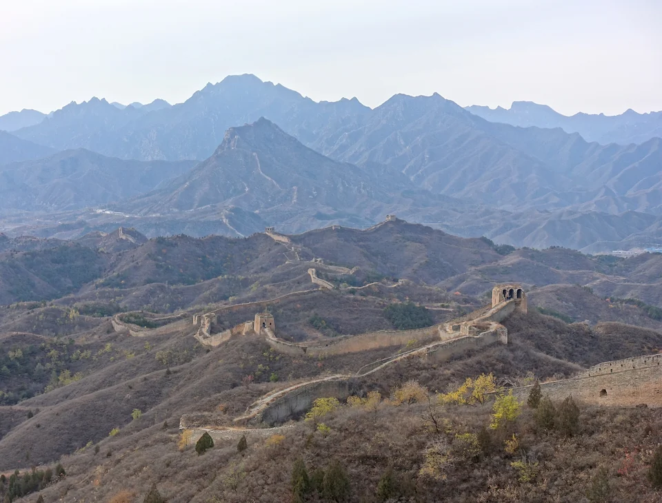The Great Wall at Gubeikou looking west, brick rampart rising over forested hills