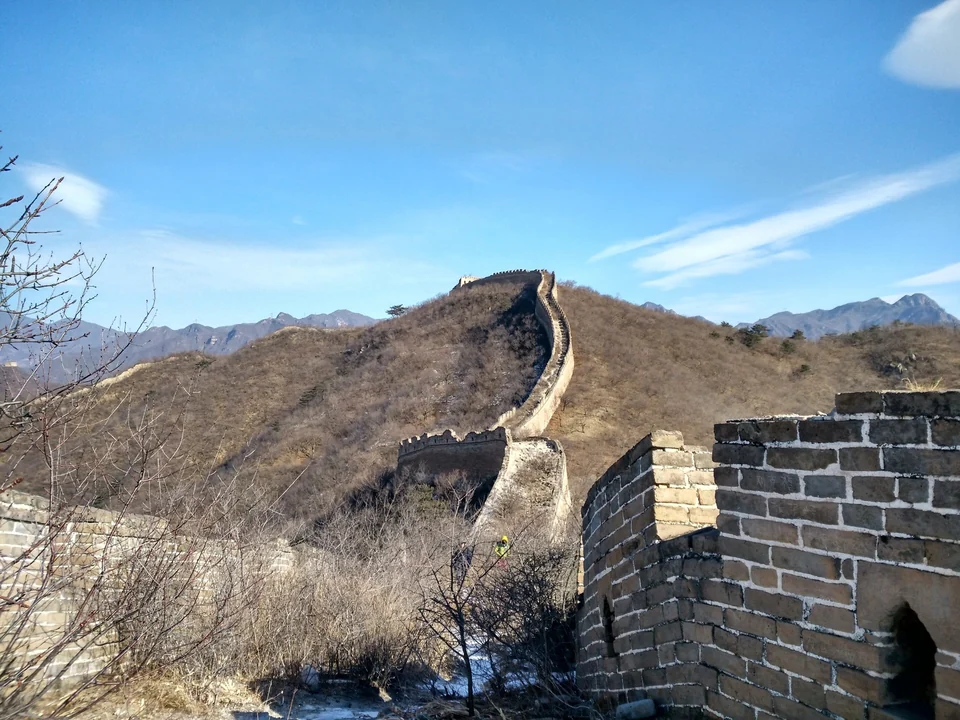 Western Huanghuacheng Great Wall in winter, a weathered brick rampart climbing a mountain slope