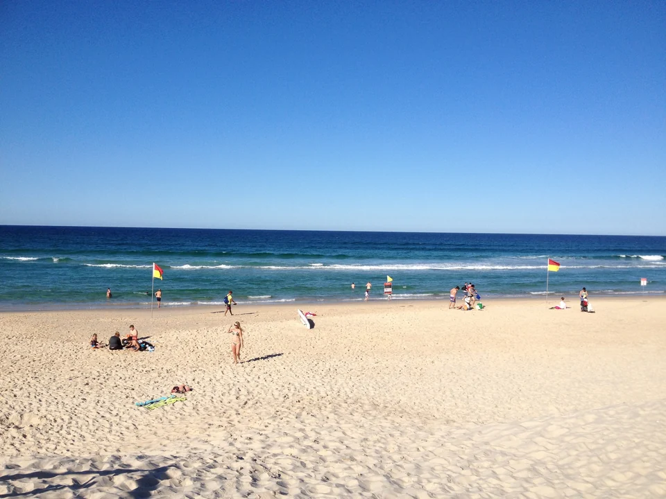 Red and yellow lifesaving flags marking the patrolled swimming area on Northcliffe Beach, Surfers Paradise, Queensland