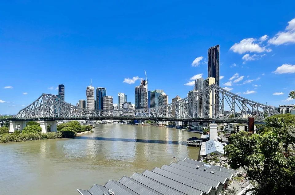 Story Bridge spanning the Brisbane River with the city skyline behind on a sunny day