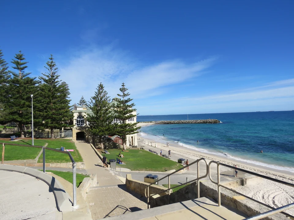 Cottesloe Beach in Perth with Norfolk Island pines, grassy terraces, white sand and a blue Indian Ocean