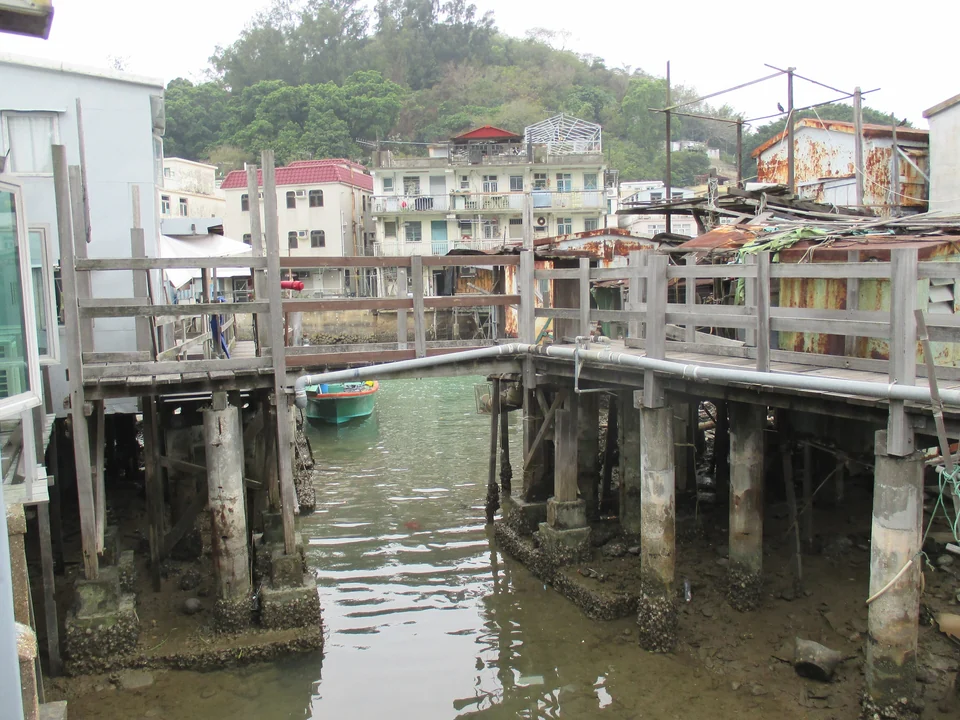 Wooden stilt houses standing over the tidal creek in the fishing village of Tai O, Lantau Island