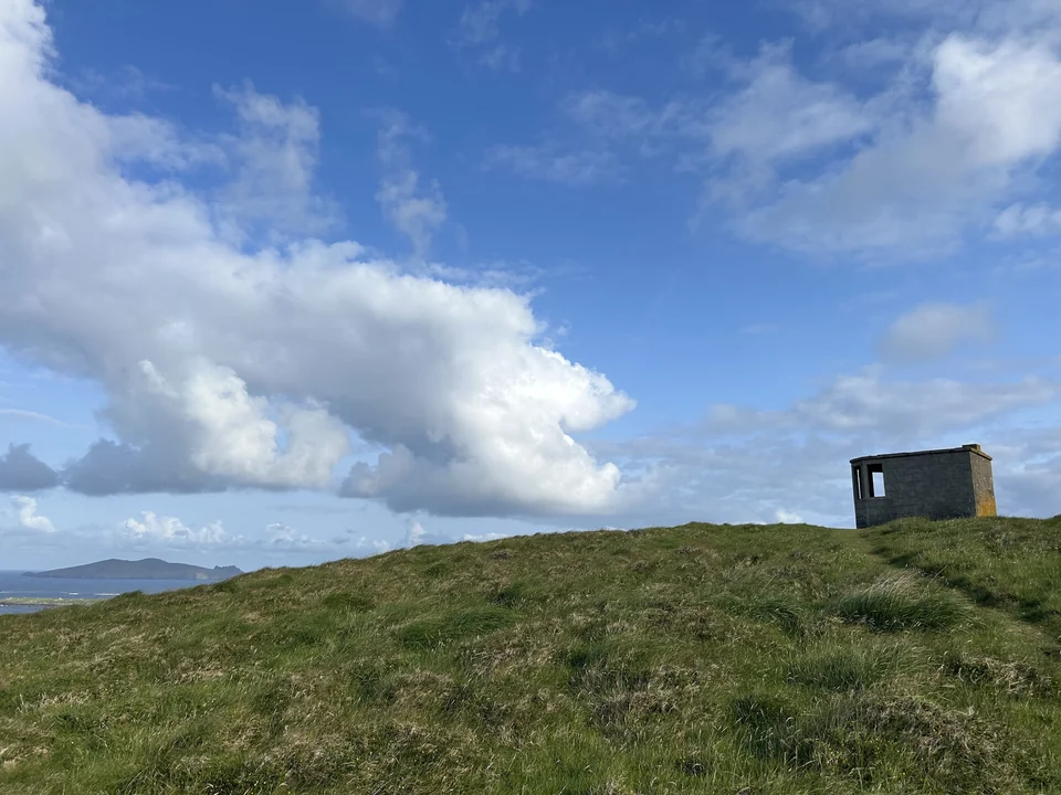Rugged coastline and green fields along the Slea Head Drive on the Dingle Peninsula