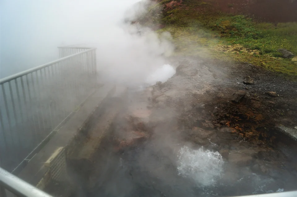 Boiling water and steam pouring from rocks at Deildartunguhver hot spring in West Iceland