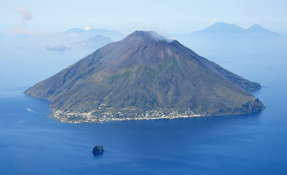 Luftaufnahme der Vulkaninsel Stromboli und des kleinen Felsinselchens Strombolicchio bei den Äolischen Inseln