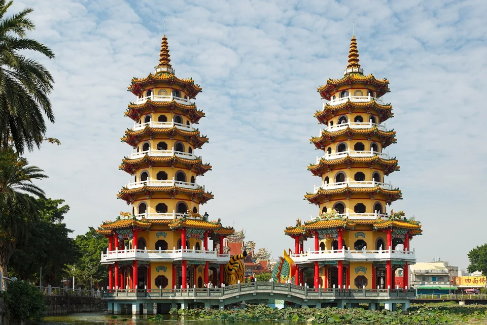 Red and yellow Dragon and Tiger Pagodas with their dragon and tiger entrances on Lotus Pond in Kaohsiung, Taiwan
