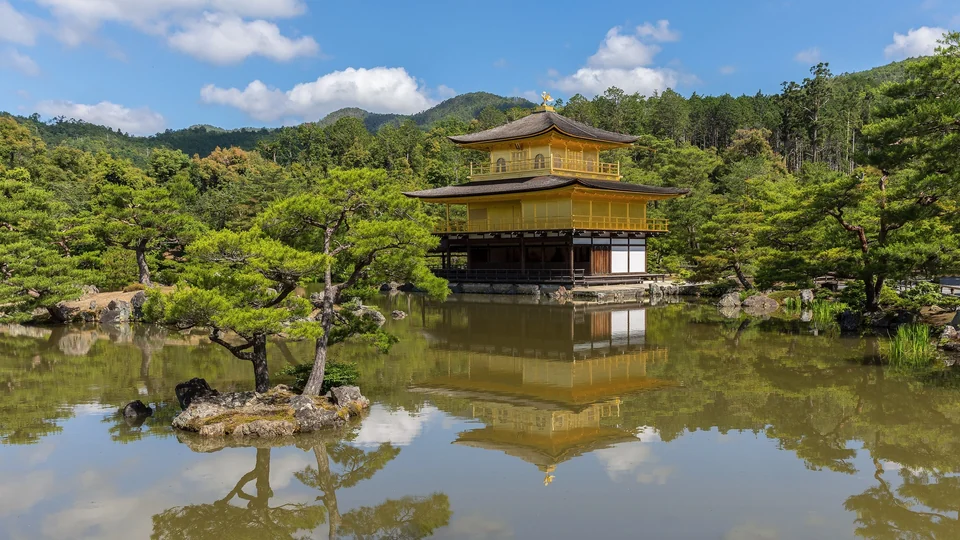 Kinkaku-ji, the Golden Pavilion, reflected in its pond on a sunny day in northern Kyoto