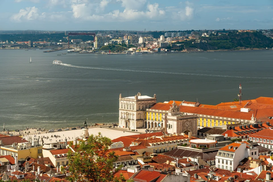 Praça do Comércio and the Rua Augusta Arch beside the wide Tagus River in Lisbon seen from above