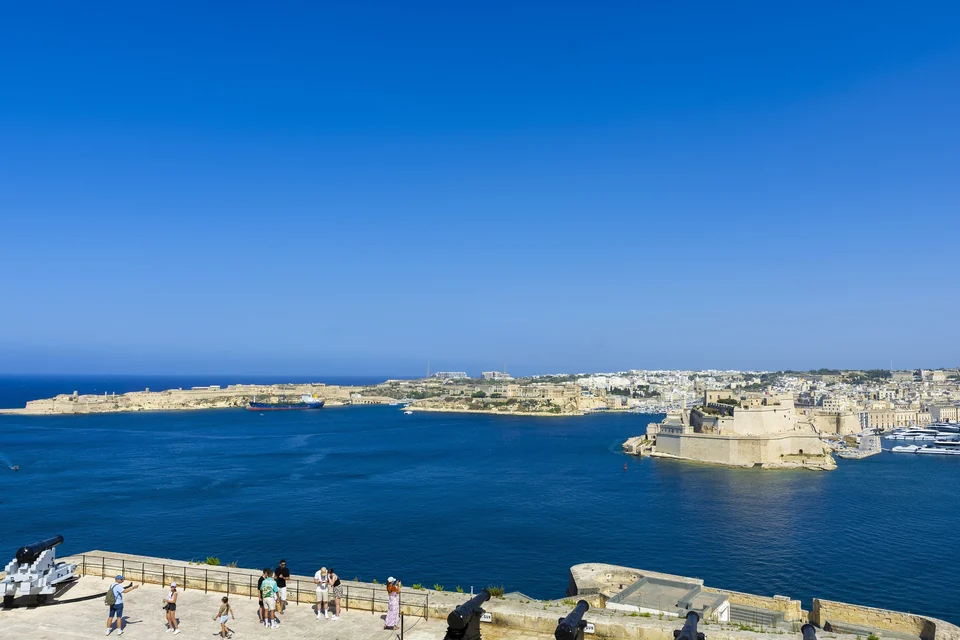 Grand Harbour and the honey-colored fortifications of the Three Cities seen from the Upper Barrakka Gardens in Valletta