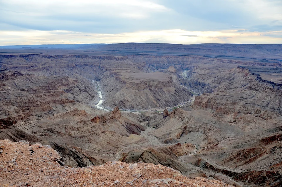 Wide view across the red-brown cliffs and winding river of Fish River Canyon in southern Namibia