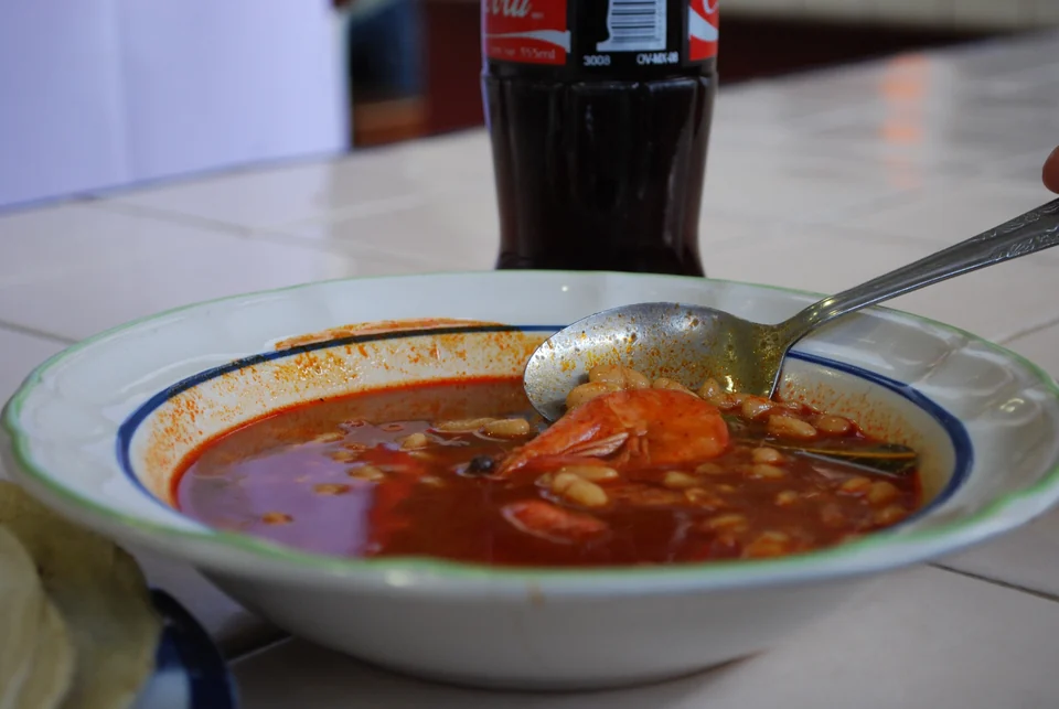 Plate of white beans and shrimp in mole coloradito at the 20 de Noviembre market in Oaxaca City