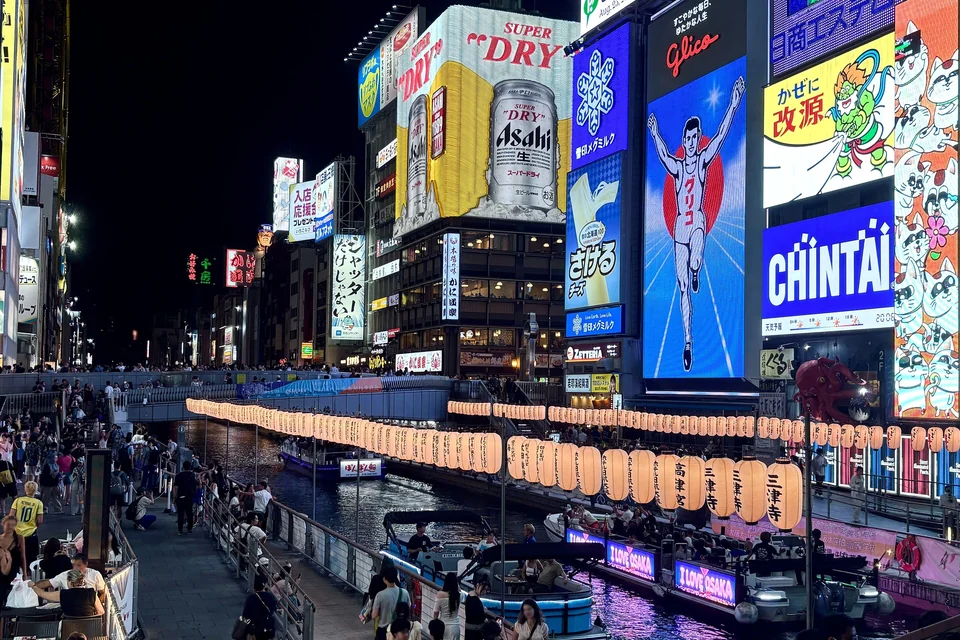 Neon signs and crowds along the Dotonbori canal in Osaka at night