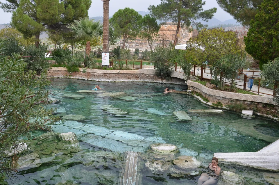 Swimmers in the clear warm water of the Antique Pool at Hierapolis, with fallen marble columns on the bottom