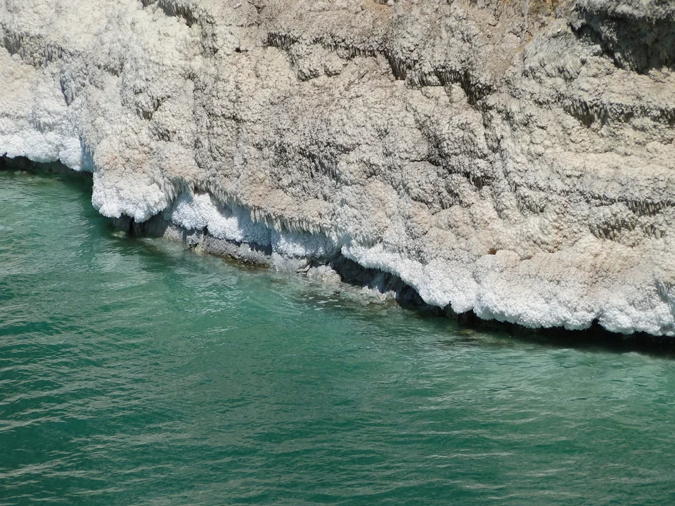 White salt deposits crusted on rocks along the Jordanian shore of the Dead Sea