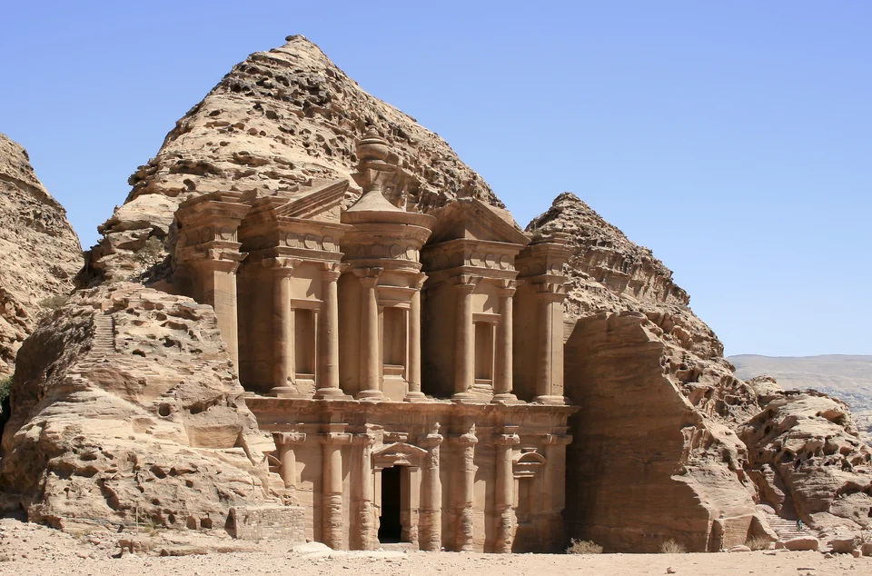 The massive carved facade of Ad Deir, the Monastery, on a mountaintop plateau above Petra, Jordan