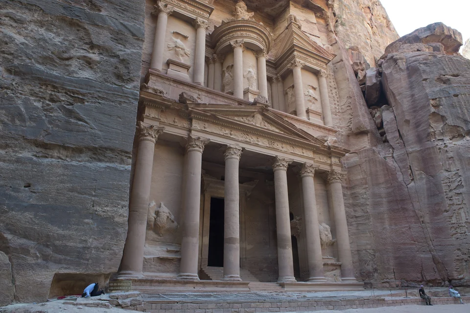 The rock-cut facade of Al-Khazneh, the Treasury, framed by the sandstone walls of the Siq in Petra, Jordan