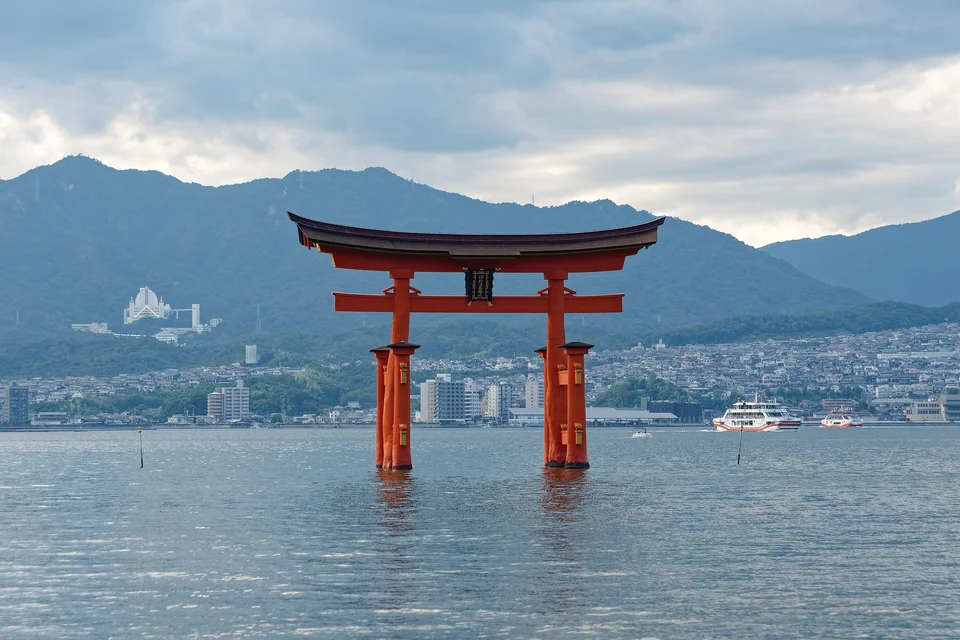 The vermilion Otorii gate of Itsukushima Shrine standing in the sea off Miyajima island at high tide
