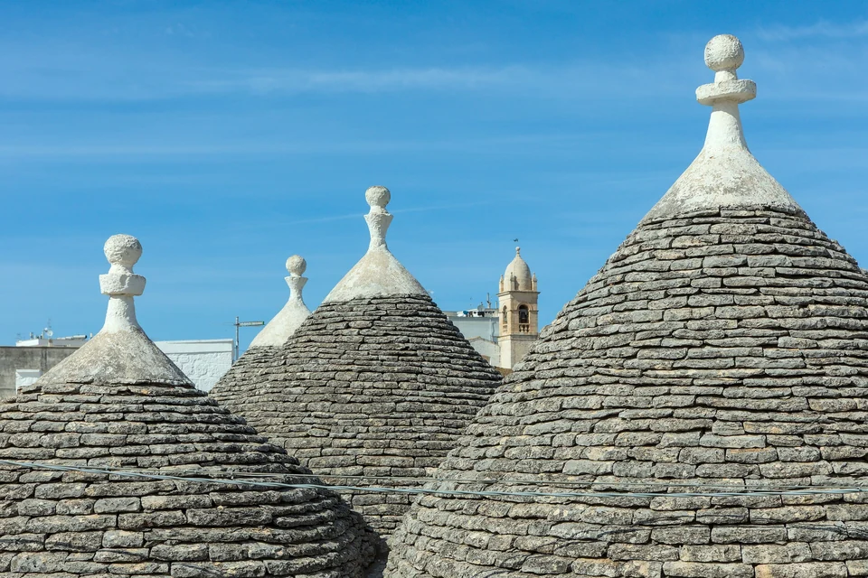 Conical dry-stone trullo roofs with whitewashed pinnacles in the Rione Monti quarter of Alberobello, Puglia