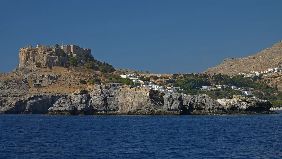White houses of Lindos below the clifftop acropolis on Rhodes, seen from the north-east