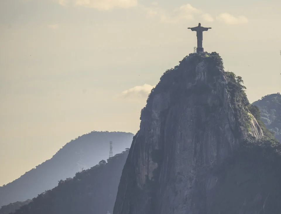 Christ the Redeemer statue with outstretched arms on top of Corcovado mountain in Rio de Janeiro