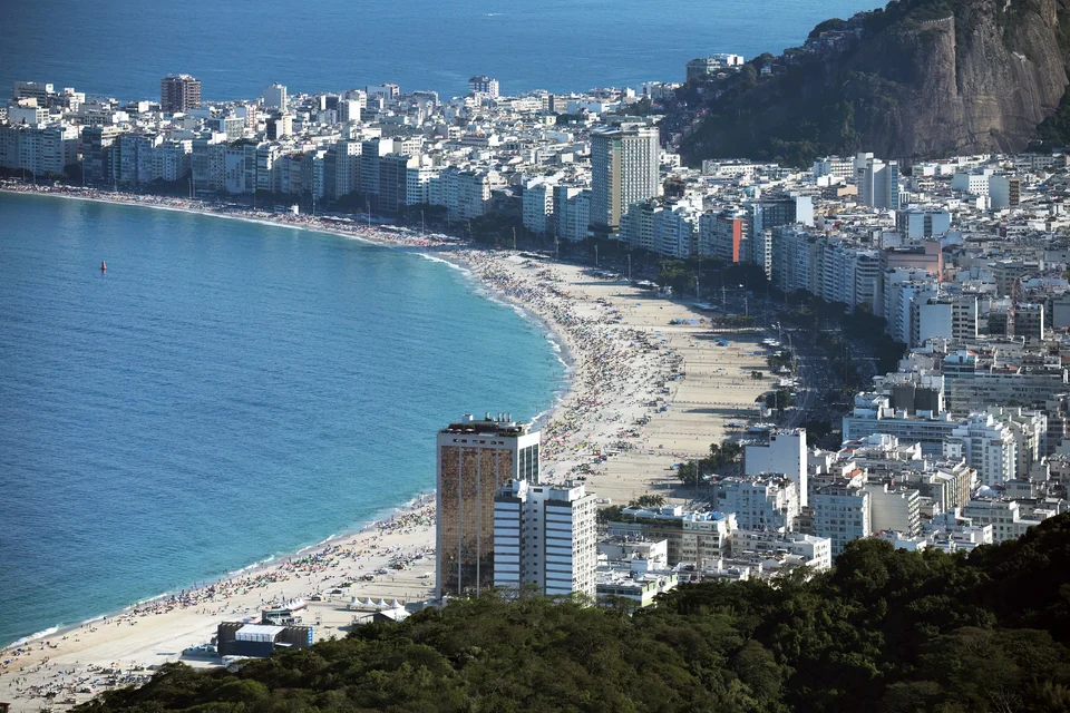 Aerial view of Copacabana beach and its curving seafront in Rio de Janeiro, with the city and mountains behind
