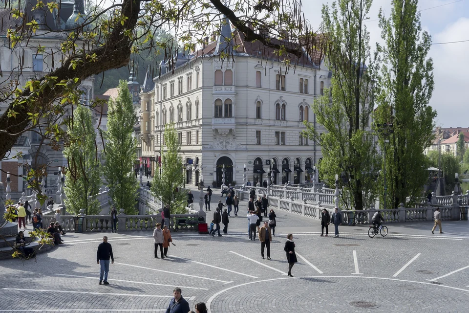 Plečnik's Triple Bridge over the Ljubljanica River in central Ljubljana with the Franciscan church behind