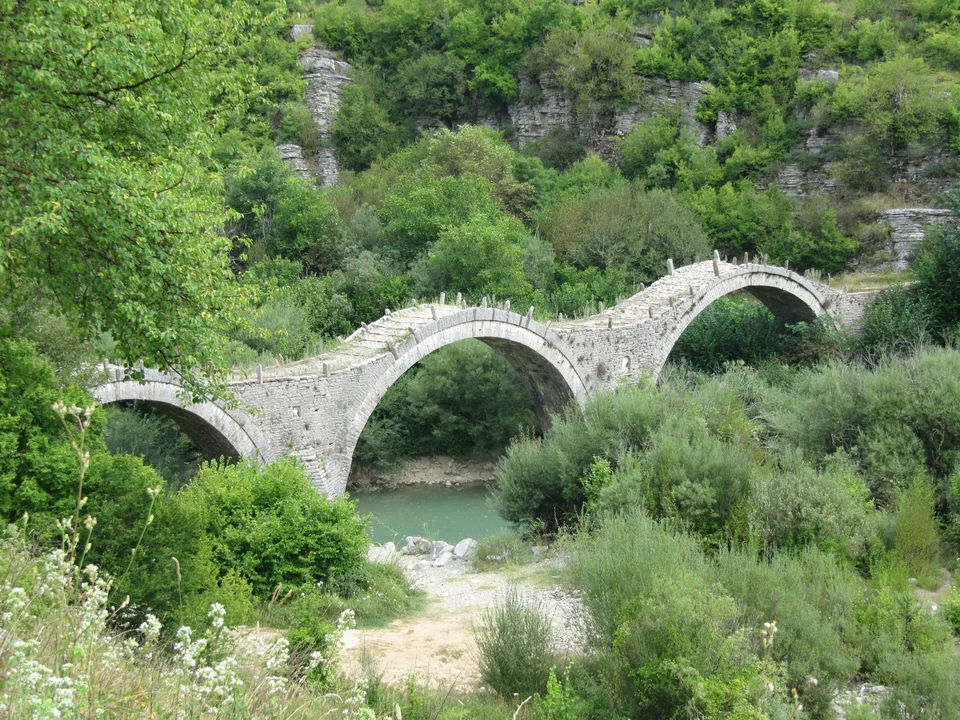 Triple-arched Plakida stone bridge near Kipi village in the Zagori region of Epirus, Greece
