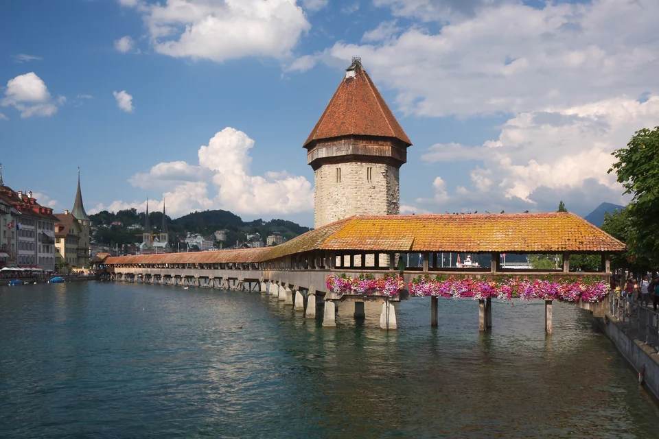 Covered wooden Chapel Bridge and its octagonal water tower crossing the Reuss river in Lucerne