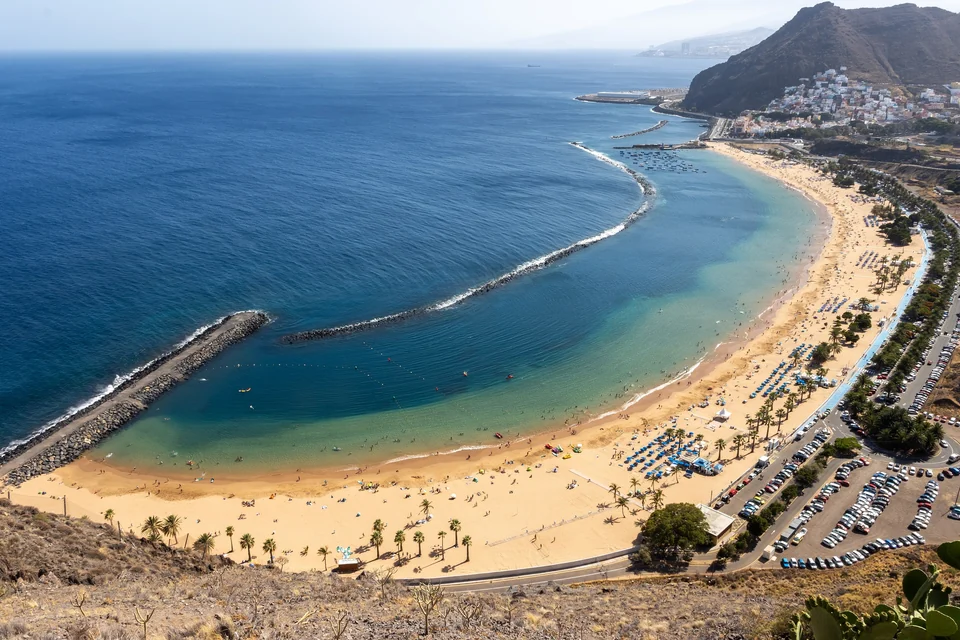 Playa de Las Teresitas, a long curved beach with palms and mountains near Santa Cruz de Tenerife